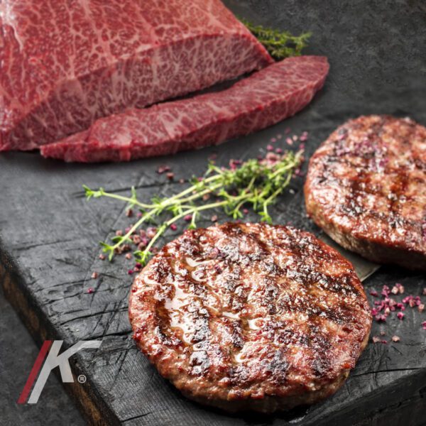Barbecue Wagyu Hamburger with red wine salt and herbs as closeup
