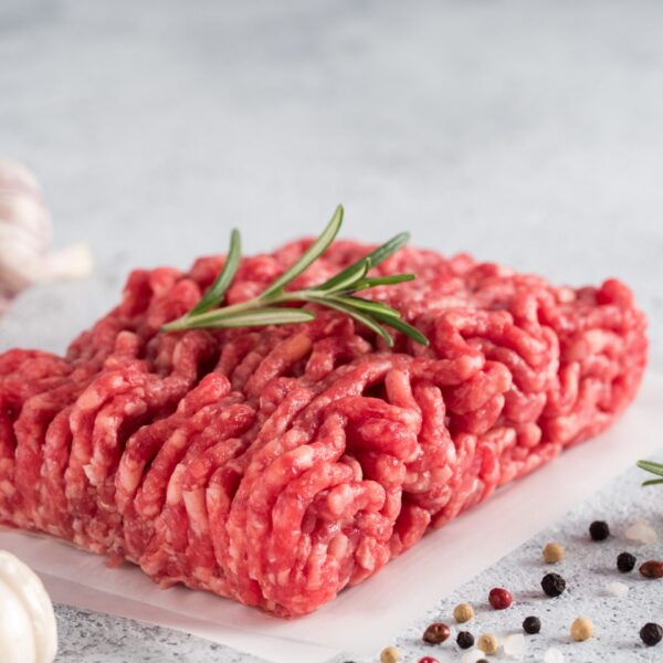 raw minced beef on light gray cement background